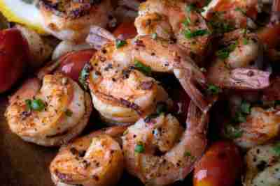 Grilled shrimps prawn with seasoning and herbs serve in plate with in door lighting.