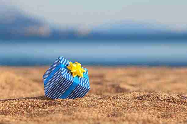 Blue gift box on a beach