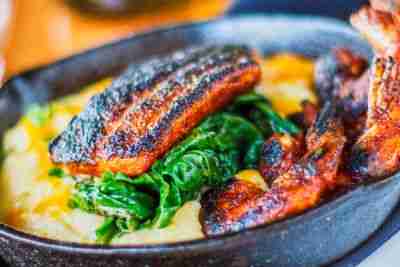 Blackened shrimp and fish served over sauteed spinach and grits