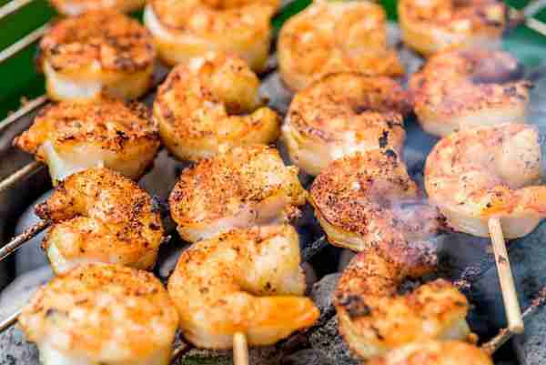 tasty spiced shrimp skewers on a barbecue